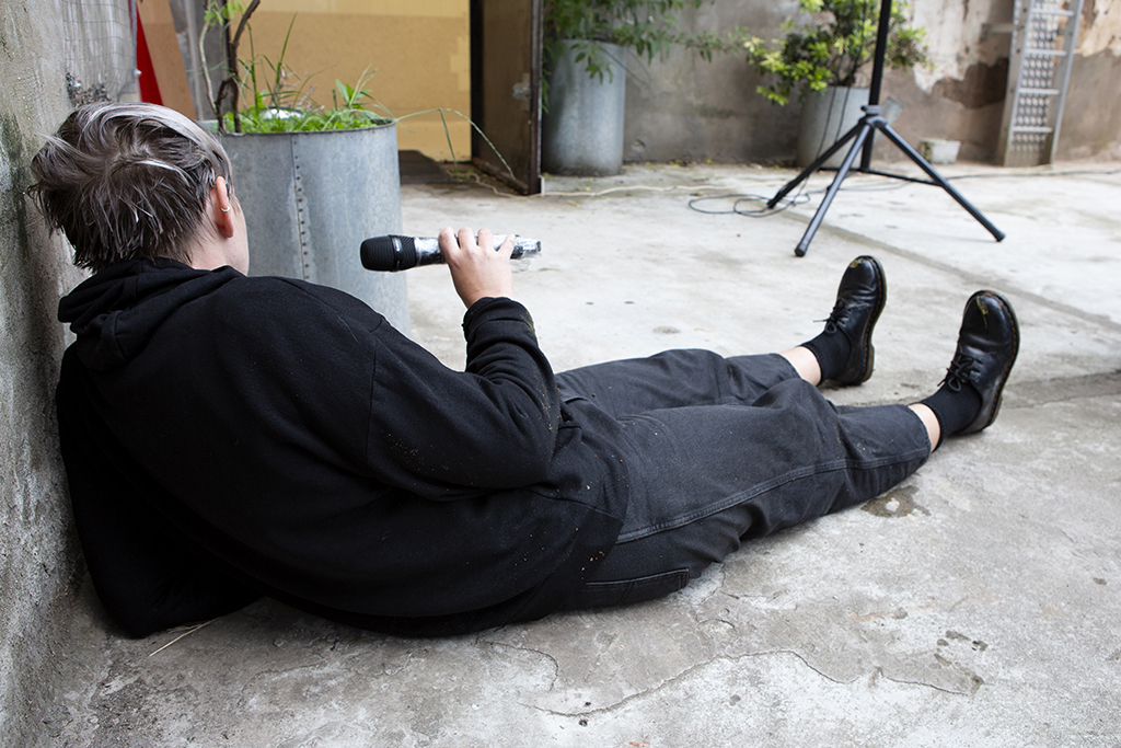 Lying down on back propped up on elbow